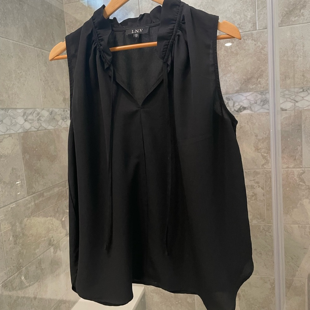 Black sleeveless up with ruffled collar. Great with a blazer. Worn once